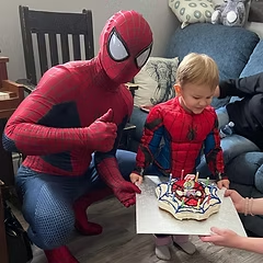 Spider-Guy with child at birthday cake